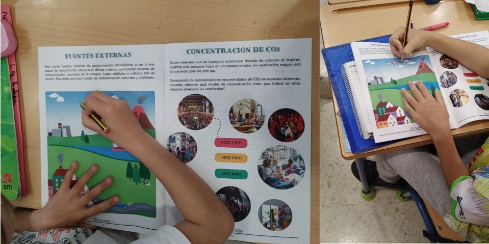 Primary school pupils seated at desks colouring EDIAQI worksheets: one page shows “Fuentes externas” with a landscape of pollution sources, while another displays “Concentración de CO₂” with illustrated indoor settings and ppm levels.
