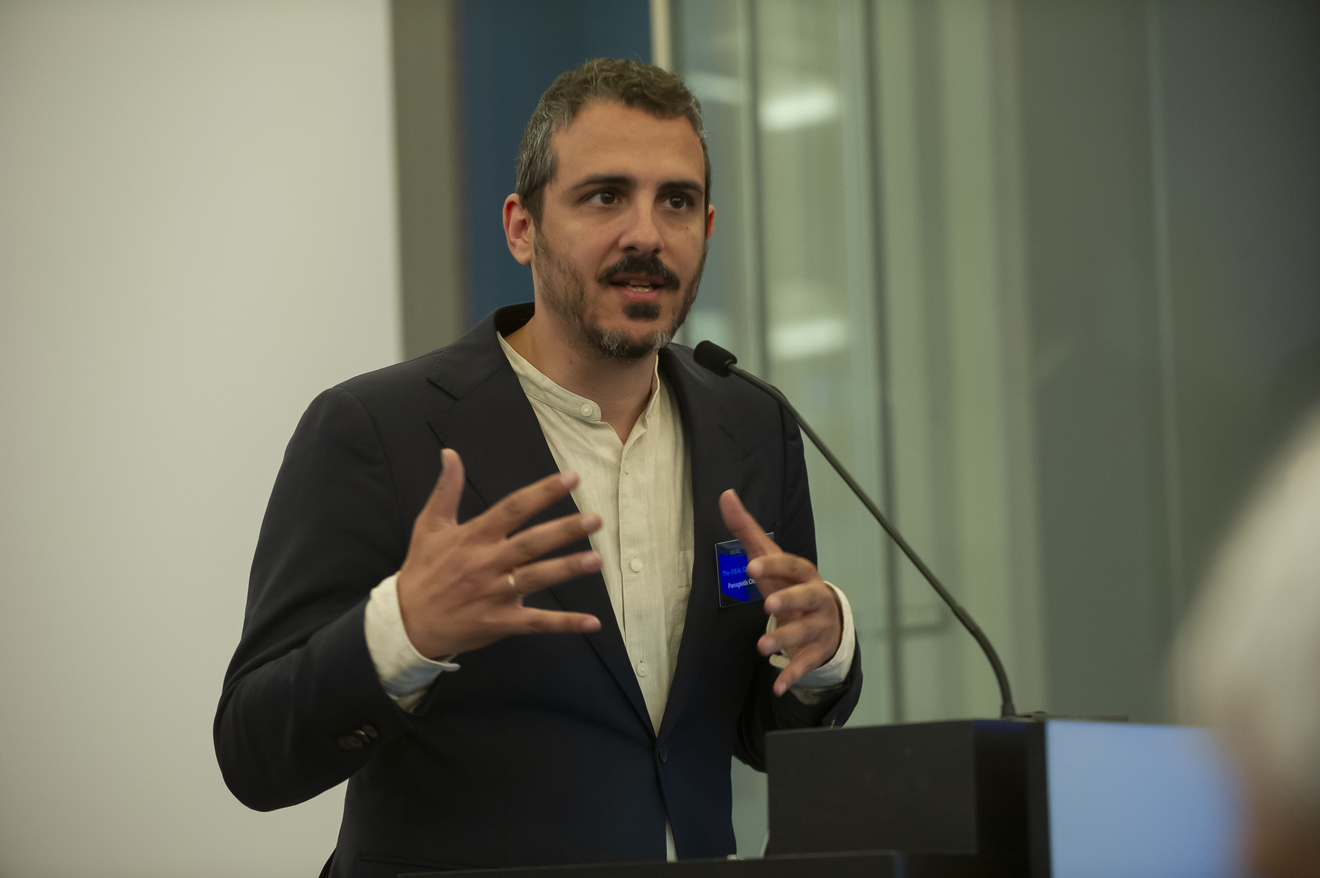 Panagiotis Chaslaridis, Senior Policy Advisor at the European Federation of Allergy and Airways Disease Patients Associations (EFA), moderates the "Improving Indoor Air Quality in Europe – A Political Imperative" session at the IDEAL Cluster Summit – The Air We Share in Brussels, guiding a high-level discussion on strengthening European policy and collaboration to improve indoor air quality.