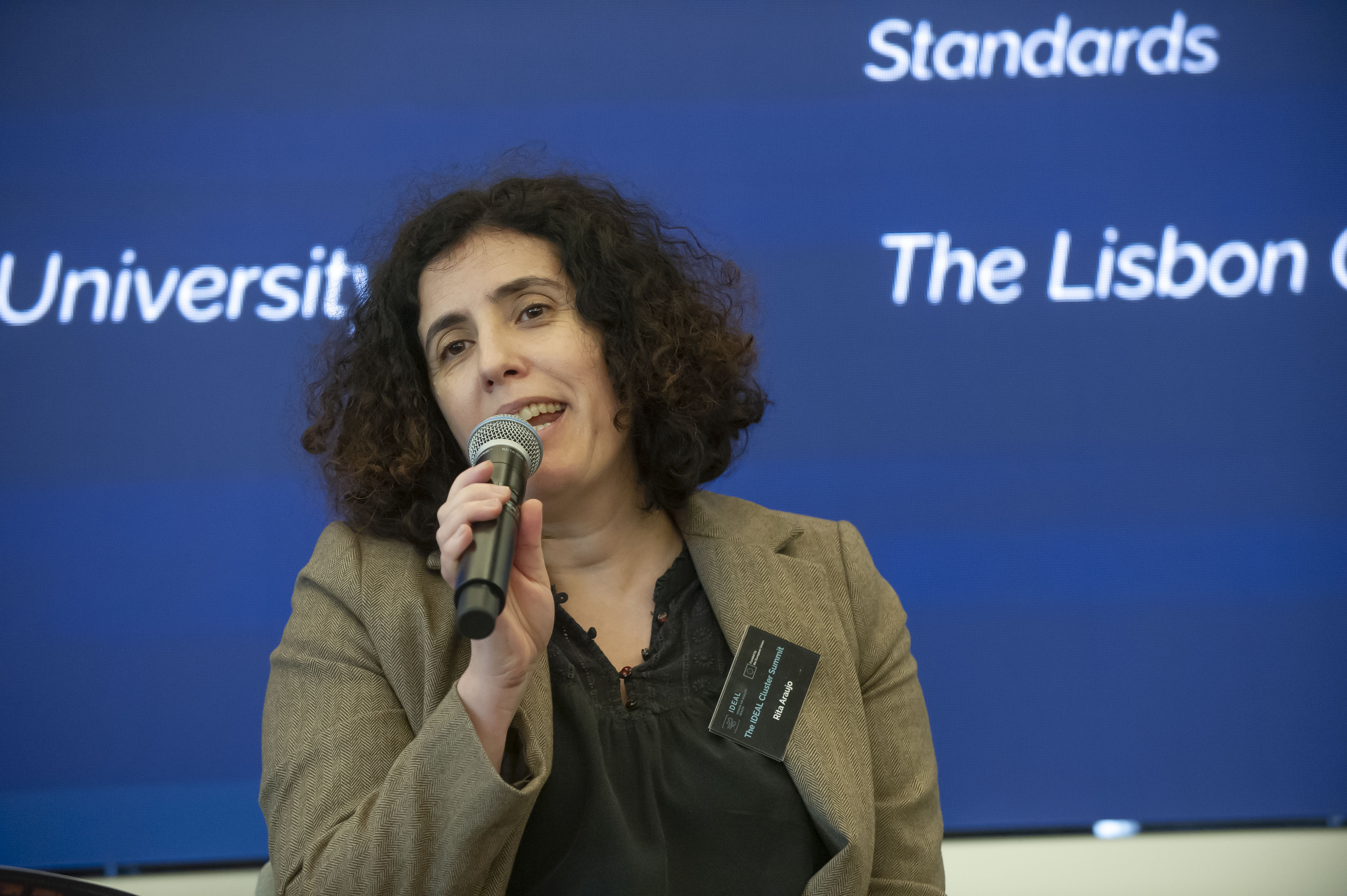 Rita Araujo, Policy Officer at the European Commission's Directorate-General for Research and Innovation (DG RTD), speaks during the "Improving Indoor Air Quality in Europe – A Political Imperative" panel at the IDEAL Cluster Summit – The Air We Share in Brussels. She discusses the role of research and innovation in supporting evidence-based policymaking and healthier indoor environments across Europe.
