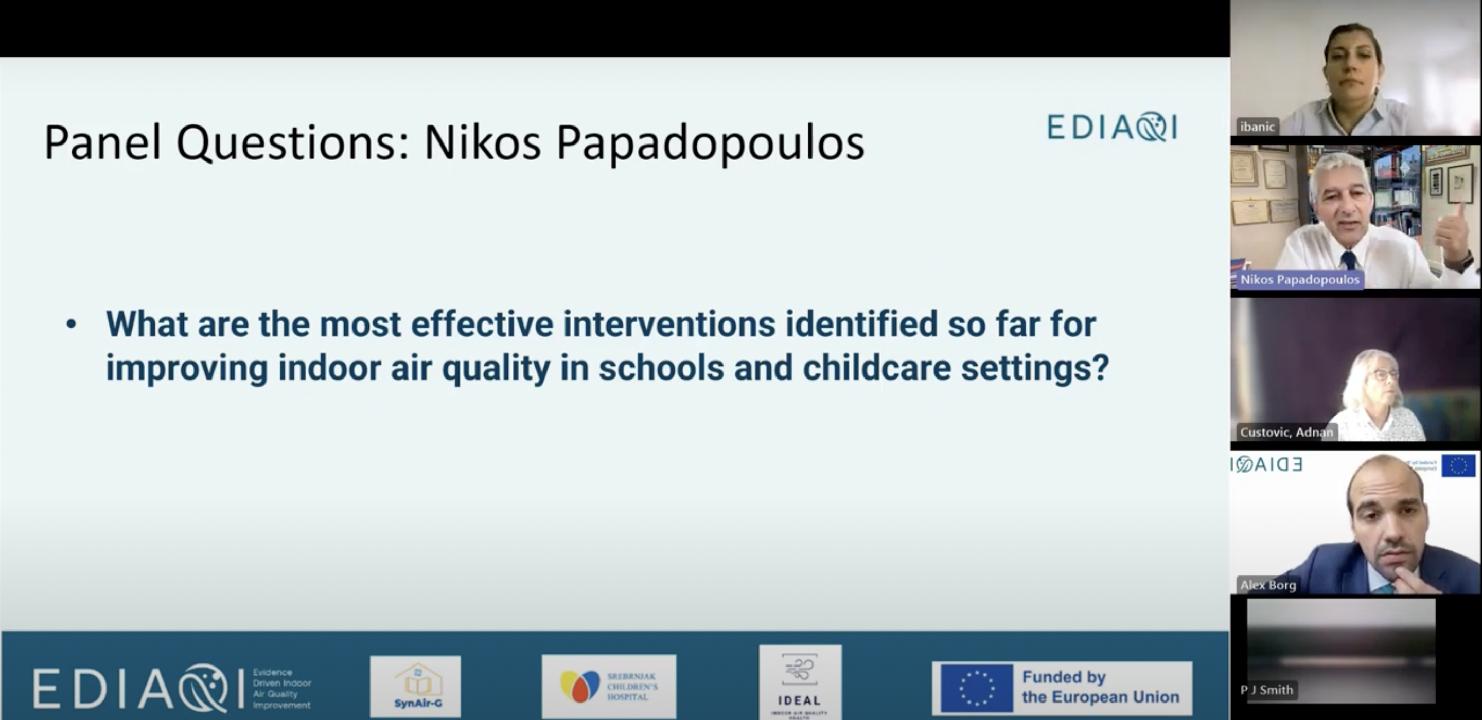 Slide from the panel discussion during the webinar, titled “Panel Questions: Nikos Papadopoulos,” displaying a question in bold blue text on a light blue background: “What are the most effective interventions identified so far for improving indoor air quality in schools and childcare settings?” The top right features the EDIAQI logo, and the bottom banner shows logos for EDIAQI, SynAir-G, Srebrnjak Children’s Hospital, IDEAL (Indoor Air Quality project), and the European Union with a note that the project is funded by the EU. Along the right side of the slide are five video call frames showing Dr. Ivana Banic (top) listening attentively, Nikos Papadopoulos (second from top) gesturing as he speaks, Professor Adnan Custovic (middle) watching quietly, Alex Borg (moderator, second from bottom) paying close attention with the EDIAQI logo and EU flag in his frame, and a participant labeled P J Smith (bottom) with their camera blurred or inactive.