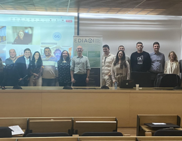 Photo of Consortium members present in Seville in Front of Project with online partners also visible.