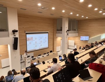  Participants seated in a tiered lecture hall during the EDIAQI Indoor Air Quality Conference in Zagreb.
