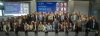 Participants gather for a group photograph at the IDEAL Cluster Summit – The Air We Share: Shaping Healthier Indoor Air Quality in Europe and Beyond in Brussels. Researchers, policymakers, industry representatives, public authorities and civil society organisations from across Europe stand together in front of the Summit stage, representing the seven Horizon Europe projects of the IDEAL Cluster and celebrating their shared commitment to advancing healthier indoor environments through research, innovation an